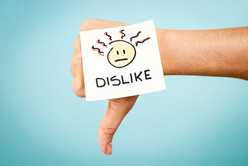 Image of a hand with a dislike emoji sticker making the thumbs down sign