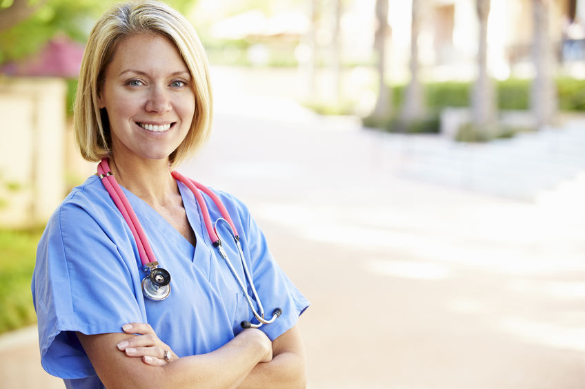 Outdoor portrait of a smiling female nurse.