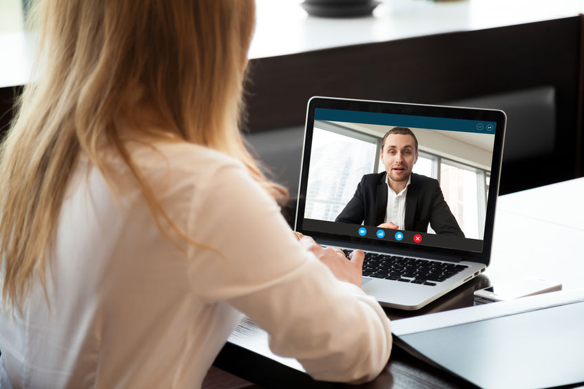 A female physician recruiter is conducting a virtual interview with a physician job candidate.