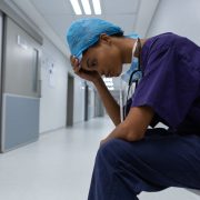 A picture of a nurse or physician suffering from anxiety in a hospital