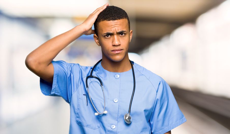 A young physician looking confused