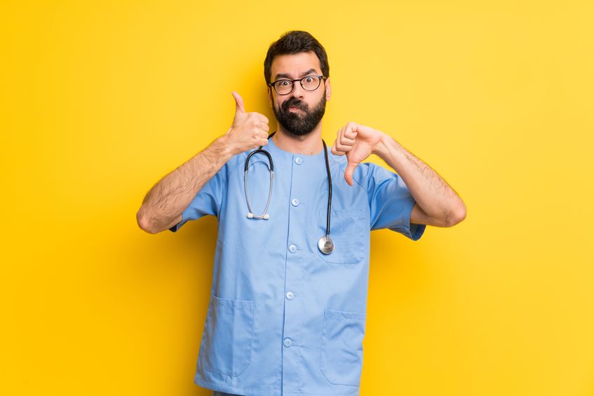 A physician evaluating work culture with thumbs up and thumbs down
