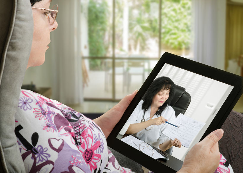A female patient consults with her physician via a telemedicine appointment